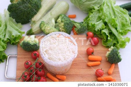 various fresh vegetables sauerkraut sauerkraut in a small jar against the background of a garland various fresh vegetables sauerkraut sauerkraut in a small jar against the background of a garland 141030071