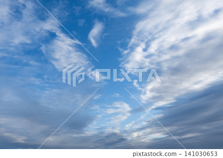 Beautiful blue sky filled with textured white clouds on a bright sunny day Beautiful blue sky filled with textured white clouds on a bright sunny day 141030653