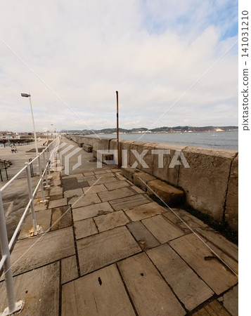 Stone Waterfront Promenade with Sea Wall and Coastal View in Northern Spain, Travel and Freedom Concept Stone Waterfront Promenade with Sea Wall and Coastal View in Northern Spain, Travel and Freedom Concept 141031210