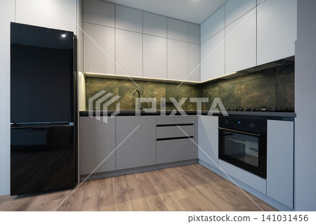 Minimalist L-shaped kitchen with grey cabinets and green marble-textured backsplash Minimalist L-shaped kitchen with grey cabinets and green marble-textured backsplash 141031456