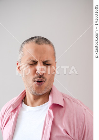 Man Making Face of Disgust or Dislike Man Making Face of Disgust or Dislike 141031605