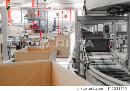 packing line in a logistics warehouse. conveyor belt in a modern production line. Pallet racking packing line in a logistics warehouse. conveyor belt in a modern production line. Pallet racking 141031733