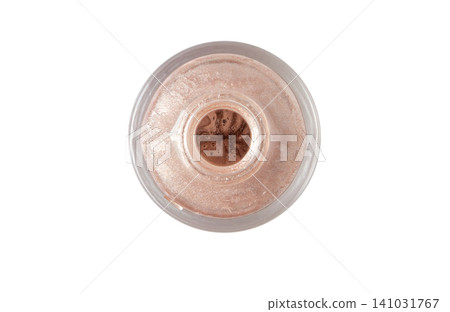 Open glass bottle of pearlescent nude nail polish top view isolated on white Open glass bottle of pearlescent nude nail polish top view isolated on white 141031767