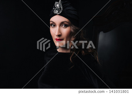 Elegant young woman and girl in 1920s vintage style wearing a velvet turban Elegant young woman and girl in 1920s vintage style wearing a velvet turban 141031801