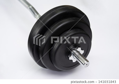 Close-up of barbell weight plates with star lock collar on white background Close-up of barbell weight plates with star lock collar on white background 141031843