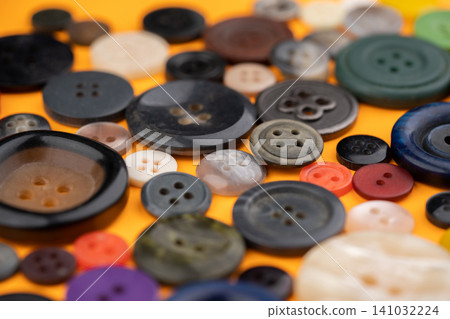Many different buttons on a yellow background Many different buttons on a yellow background 141032224