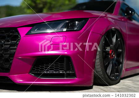 Close-up of pink modified sport car with black alloy wheels Close-up of pink modified sport car with black alloy wheels 141032302