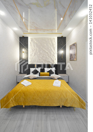 Luxury hotel-style bedroom with mustard yellow bedspread and textured feature wall Luxury hotel-style bedroom with mustard yellow bedspread and textured feature wall 141032452