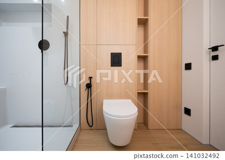 Modern minimalist bathroom with wood paneling and walk-in shower 141032492