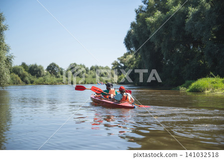 a team of athletes on a canoe overcomes obstacles floating on the river a team of athletes on a canoe overcomes obstacles floating on the river 141032518