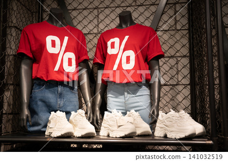Mannequins in red t-shirts with large percentage symbols for a 50% off sale Mannequins in red t-shirts with large percentage symbols for a 50% off sale 141032519