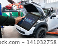 Checking the battery pack of an electric car at a service center. 141032758