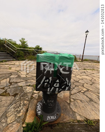 Graffiti Covered Public Trash Bin on Coastal Promenade in Northern Spain Graffiti Covered Public Trash Bin on Coastal Promenade in Northern Spain 141032813