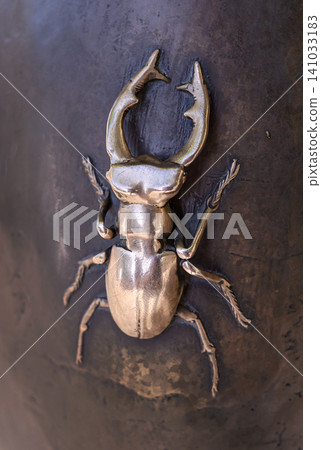 KYIV, UKRAINE - SEPTEMBER 24, 2024: Bronze stag beetle close up as a fragment of the monument "Chasing Two Hares" on Andreevsky Descent in Kyiv KYIV, UKRAINE - SEPTEMBER 24, 2024: Bronze stag beetle close up as a fragment of the monument "Chasing Two Hares" on Andreevsky Descent in Kyiv 141033183