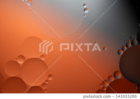 Oil drops forming an abstract pattern on a water surface Oil drops forming an abstract pattern on a water surface 141033200