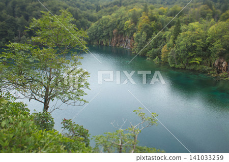 High-angle view of the vibrant blue waters and lush forested shores of Plitvice Lakes National Park, Croatia 141033259