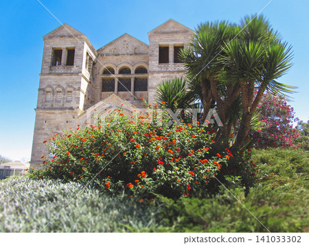 Facade of the Basilica of the Transfiguration on Mount Tabor through lush greenery Facade of the Basilica of the Transfiguration on Mount Tabor through lush greenery 141033302