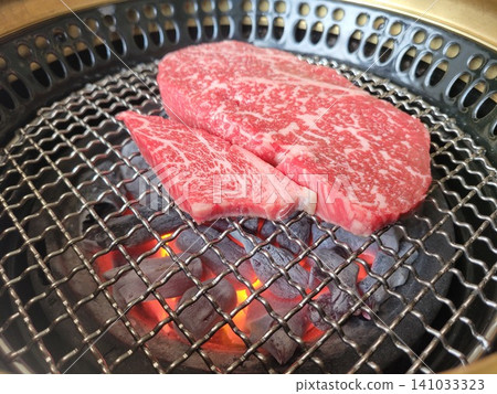 Premium Korean Hanwoo Ribeye Steak Grilling on Charcoal Brazier Wire Net Premium Korean Hanwoo Ribeye Steak Grilling on Charcoal Brazier Wire Net 141033323