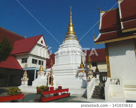 Ancient Wat Phra Kaeo Don Tao temple in Lampang with golden spire and Myanmar style architecture Ancient Wat Phra Kaeo Don Tao temple in Lampang with golden spire and Myanmar style architecture 141033632