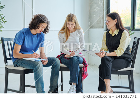 Teenagers at a group therapy session with psychologist 141033771