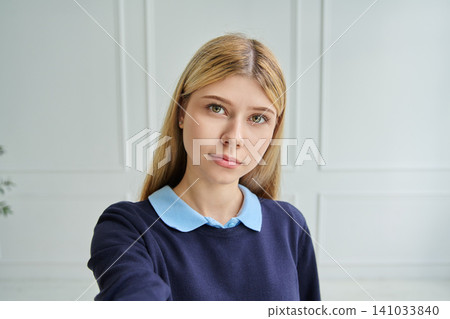 Serious teen girl aged 16-17 taking a selfie 141033840