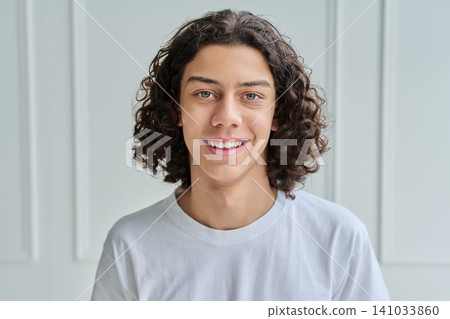 Close up of happy smiling teen boy with curly hair 141033860