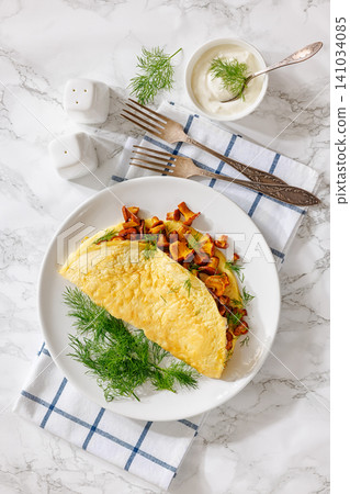 Egg omelet with fried wild chanterelles and dill Egg omelet with fried wild chanterelles and dill 141034085