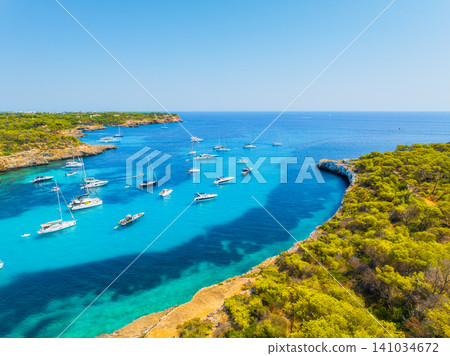 Aerial view of a sea bay and azure water in Mallorca, Spain. Aerial view of a sea bay and azure water in Mallorca, Spain. 141034672