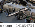 Closeup of modern diesel engine cylinder head with injectors Closeup of modern diesel engine cylinder head with injectors 141034734