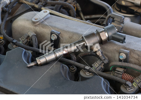 Closeup of modern diesel engine cylinder head with injectors Closeup of modern diesel engine cylinder head with injectors 141034734