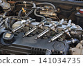Closeup of modern diesel engine cylinder head with injectors Closeup of modern diesel engine cylinder head with injectors 141034735
