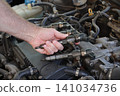 Car mechanic repair injectors of modern diesel engine Car mechanic repair injectors of modern diesel engine 141034736