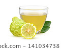 Fresh Kaffir Lime Herbal Tea in a Glass Cup with Fresh Kaffir Lime Fruits   Natural Citrus Beverage on white background. 141034738