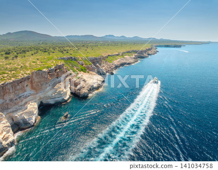 Aerial view of sea, boat near rocky cliffs of Mallorca, Spain 141034758