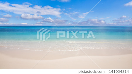 Serene turquoise sea fading into a soft horizon. Minimal tropical shore beneath a pale summer sky. Pristine calm scene for background wallpaper copy space 141034814