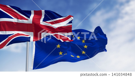Flags of United Kingdom and the European Union waving in the wind Flags of United Kingdom and the European Union waving in the wind 141034848