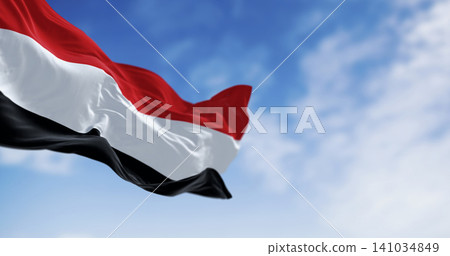 Yemen national flags waving on a clear day Yemen national flags waving on a clear day 141034849