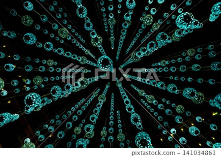 A blue, shimmering geometric ornament reminiscent of a meteor shower in space. A blue, shimmering geometric ornament reminiscent of a meteor shower in space. 141034861