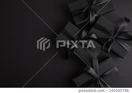 Black gift boxes with elegant silk ribbons Black gift boxes with elegant silk ribbons 141035746