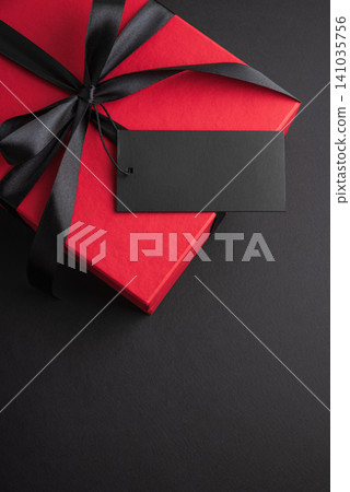 Red gift box with black ribbon and blank tag 141035756