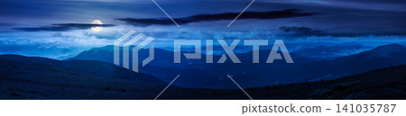 beautiful panorama of mountainous landscape at night. full moon over wide view of cloudy sky over the grassy slope of a mountain ridge. mysterious summer weather. adventure tourism in highland beautiful panorama of mountainous landscape at night. full moon over wide view of cloudy sky over the grassy slope of a mountain ridge. mysterious summer weather. adventure tourism in highland 141035787
