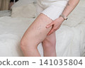 Close-up of woman's leg showing prominent varicose veins and spider veins on the thigh 141035804