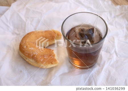 Hot tea glass with sweet pastry breakfast Hot tea glass with sweet pastry breakfast 141036299