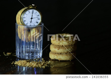 Pocket watch on biscuits in dark Pocket watch on biscuits in dark 141036355