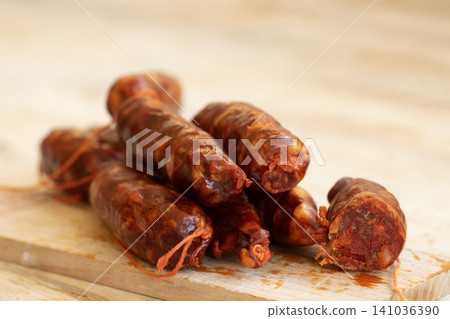 Sliced Spanish Chorizo Sausages on Wooden Cutting Board Sliced Spanish Chorizo Sausages on Wooden Cutting Board 141036390