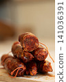 Calabrian Sausage Stacked on Wooden Board for Traditional Cuisine 141036391