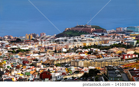 A beautiful high angle panoramic view of Santa Cruz de Tenerife city with colorful houses and the blue ocean in the background, Canary Islands, Spain A beautiful high angle panoramic view of Santa Cruz de Tenerife city with colorful houses and the blue ocean in the background, Canary Islands, Spain 141038746