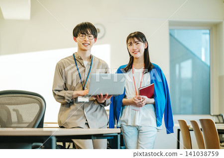 Portrait of young men and women working in the office 141038759