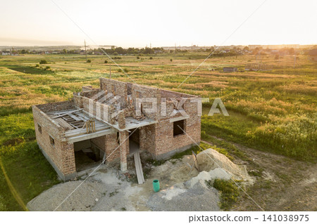 Aerial view of building site for future house, brick basement floor and stacks of brick for construction. Aerial view of building site for future house, brick basement floor and stacks of brick for construction. 141038975