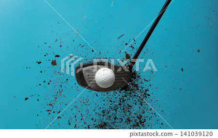 Golf ball explode from Tee off. Golfer hit ball with club to grass soil explosion on green. Golf club hit ball on green tee off with grass flying scatter. Blue sky background isolated 141039120